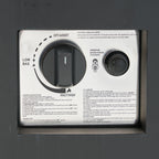 Control panel with two knobs and text on a dark background