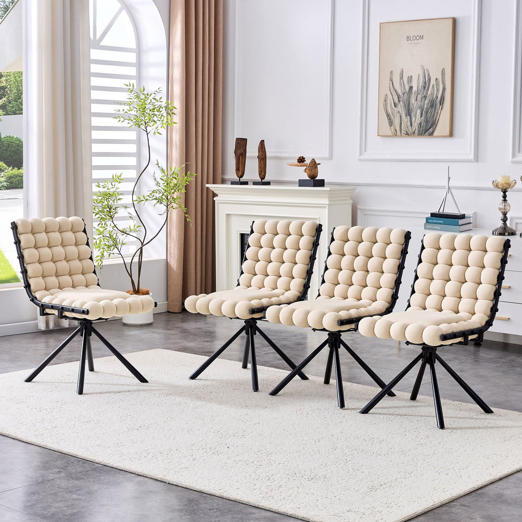 Set of four modern chairs with beige cushioned seats and black metal frames in a living room setting.