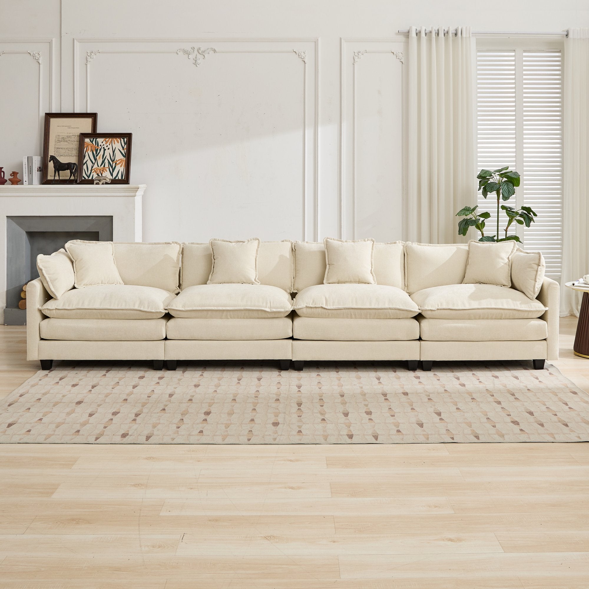Beige sectional sofa in a living room setting with a fireplace and decor.