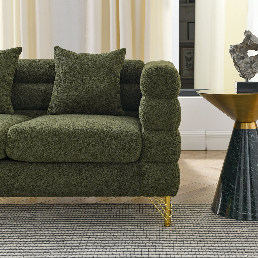 Green sofa with gold legs in a living room setting