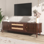 Wooden TV stand with a television mounted on the wall in a room with decorative elements.