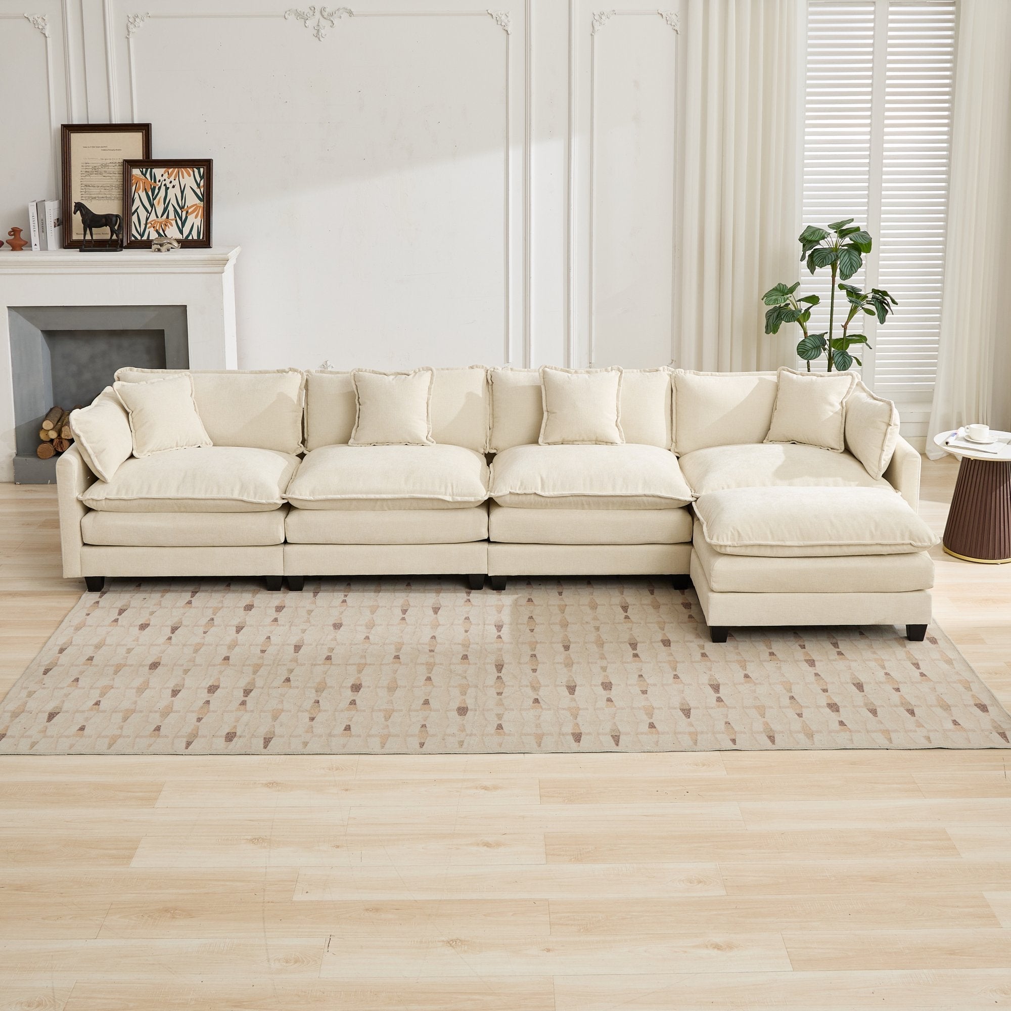 Beige sectional sofa in a living room setting with a fireplace and rug.