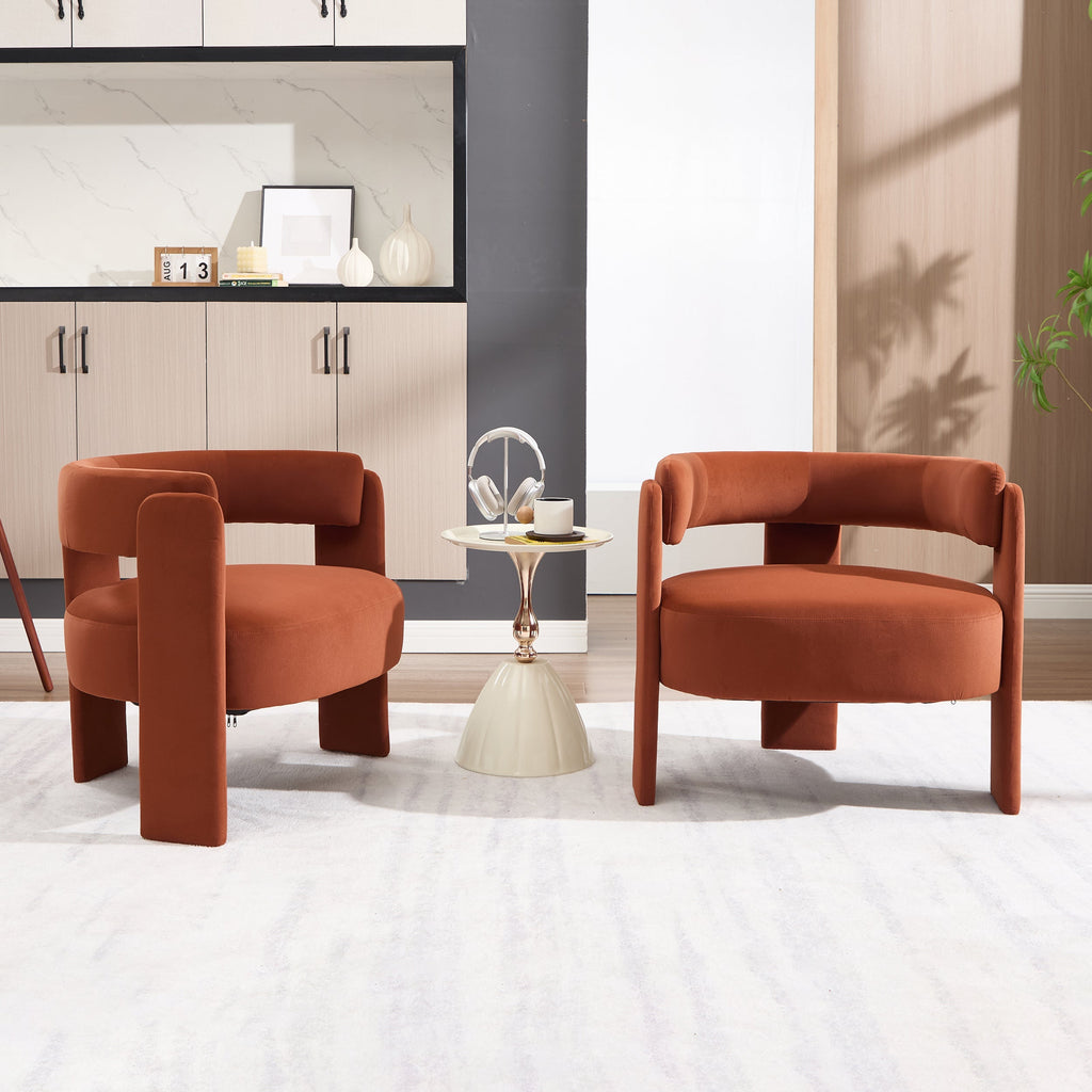 Two rust-colored armchairs in a modern living room setting with a small round table.