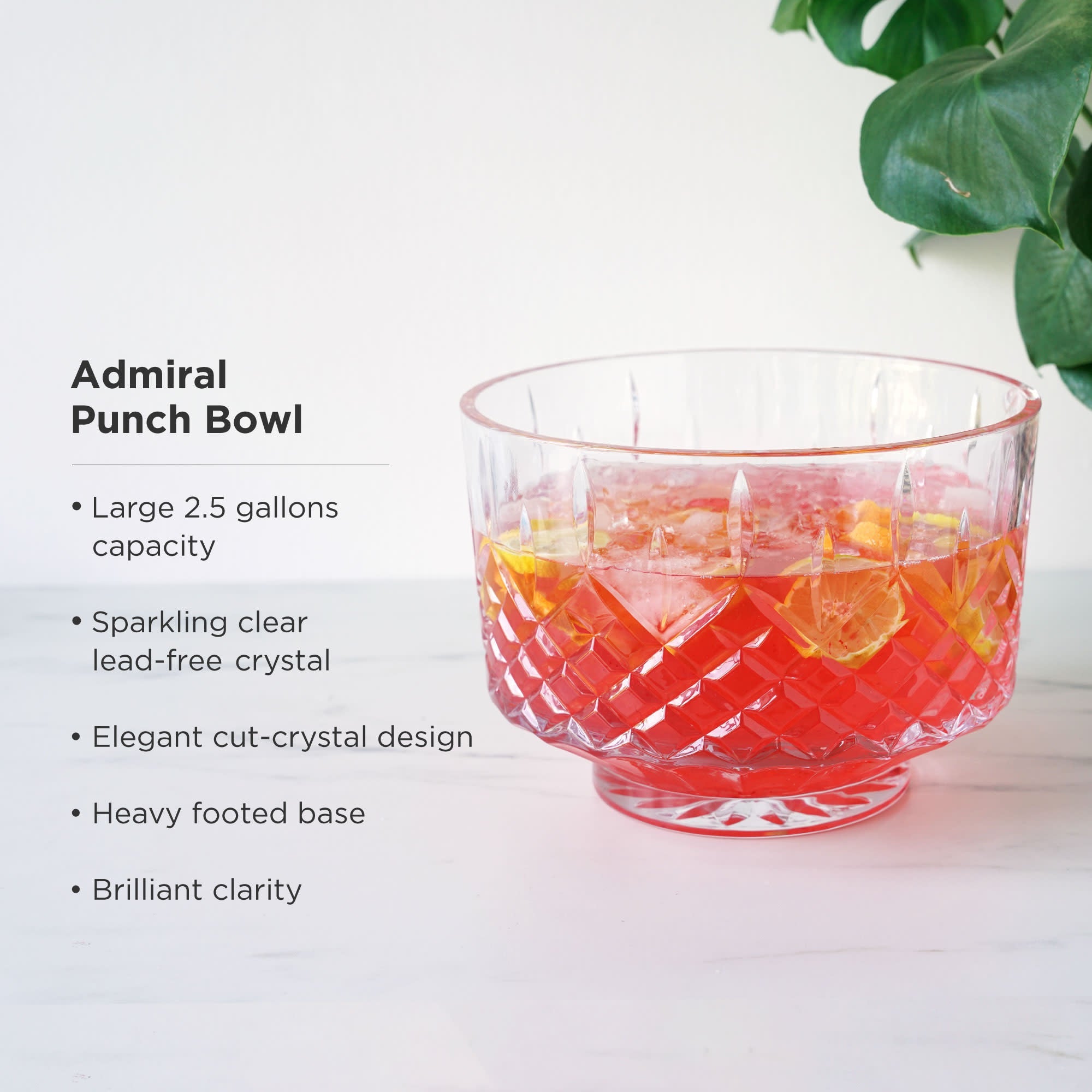 Glass punch bowl with red liquid and ice cubes on a white surface, with text describing the product.