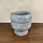 Stone mortar on a wooden surface with a neutral background