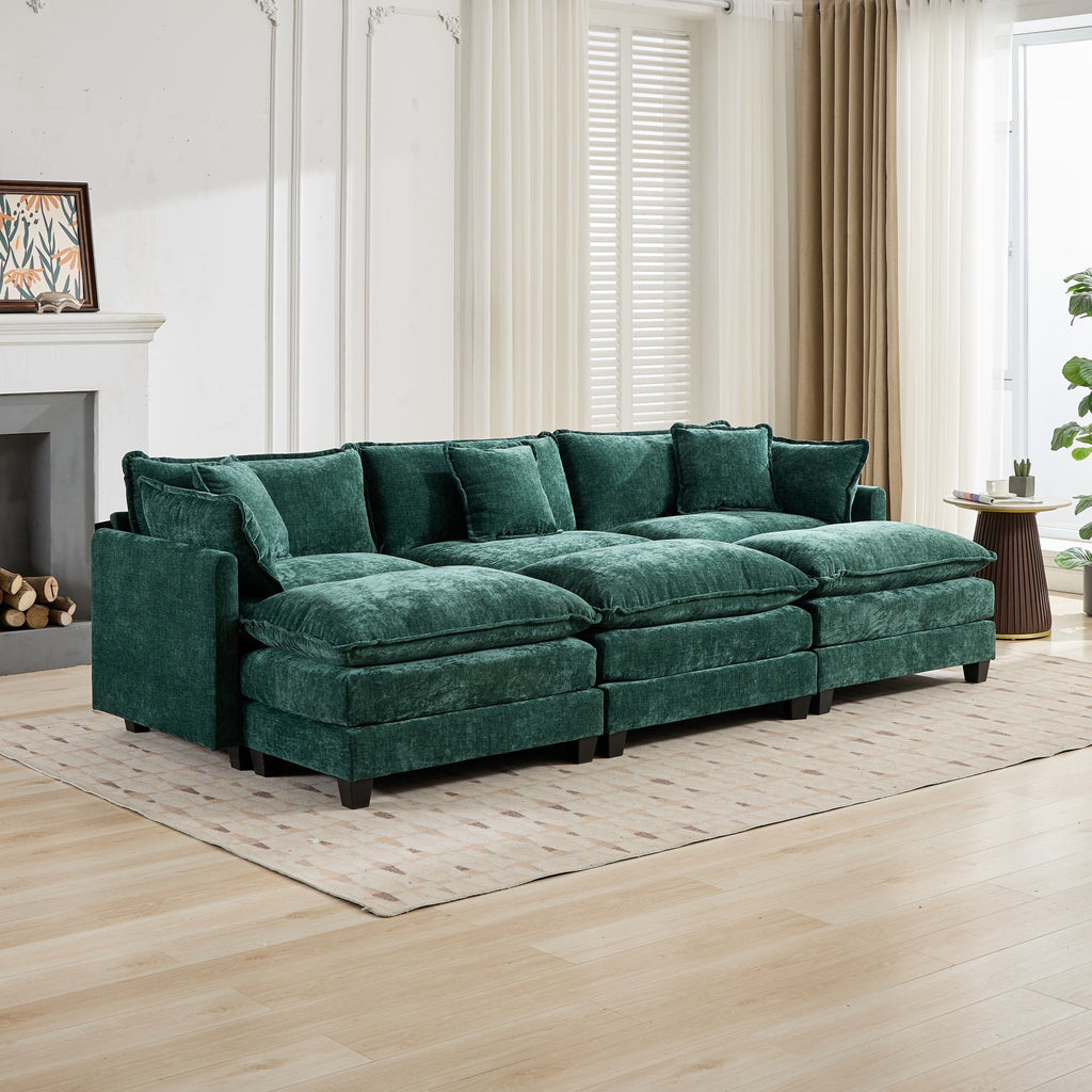 Green sectional sofa in a living room with wooden floor and white walls.
