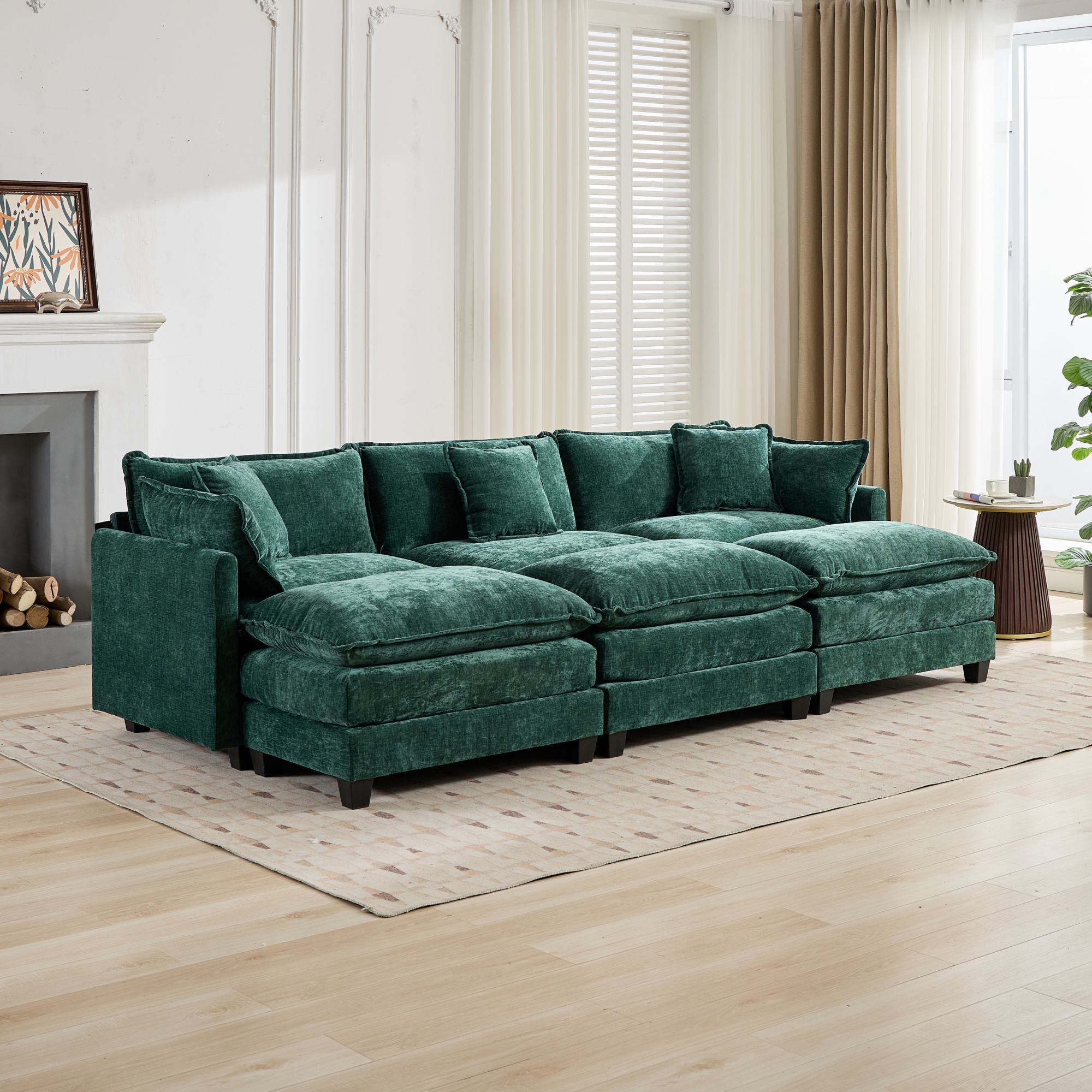 Green sectional sofa in a living room with wooden floor and white walls.