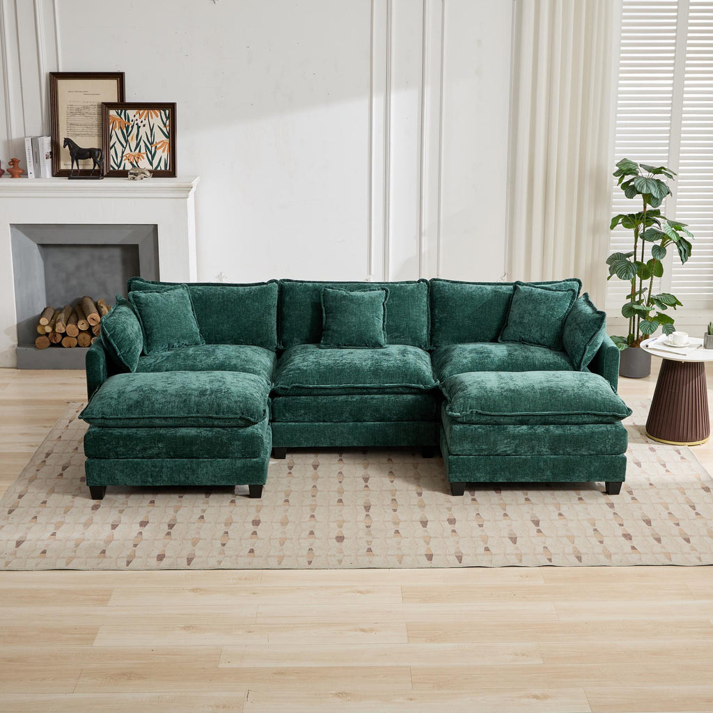 Green sectional sofa in a living room setting with a fireplace and decor.