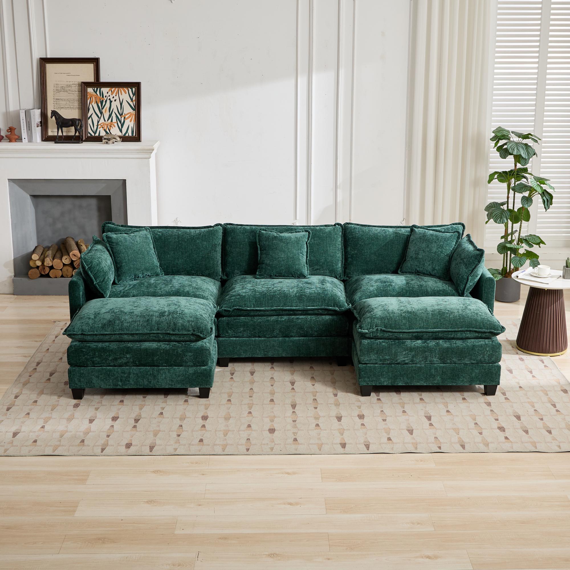 Green sectional sofa in a living room setting with a fireplace and decor.