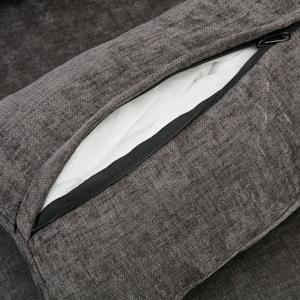 Gray textured cushion with a zipper on a dark background