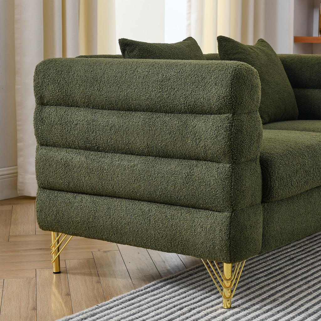 Green textured sofa with gold legs in a living room setting