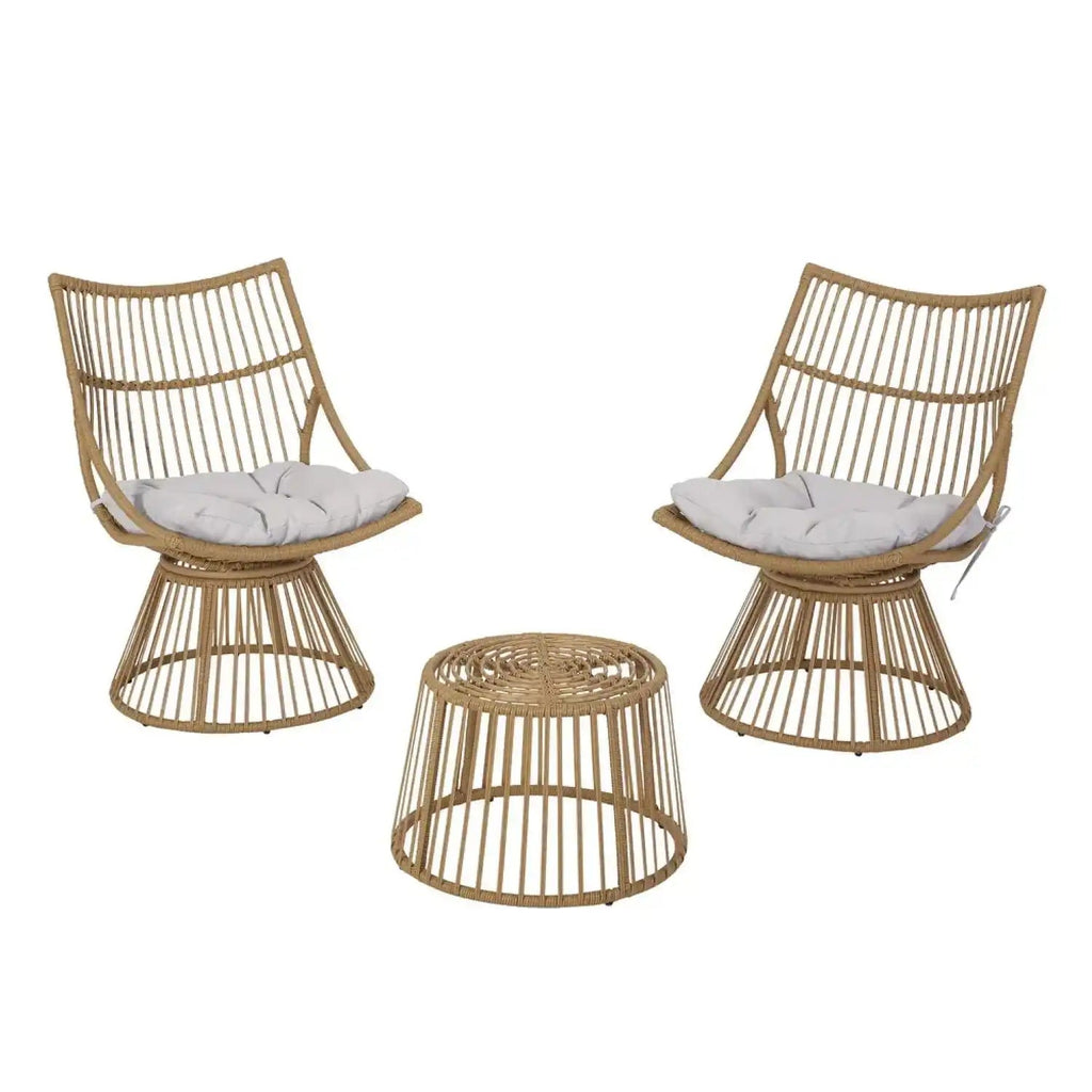 Two wicker chairs with white cushions and a matching side table on a white background