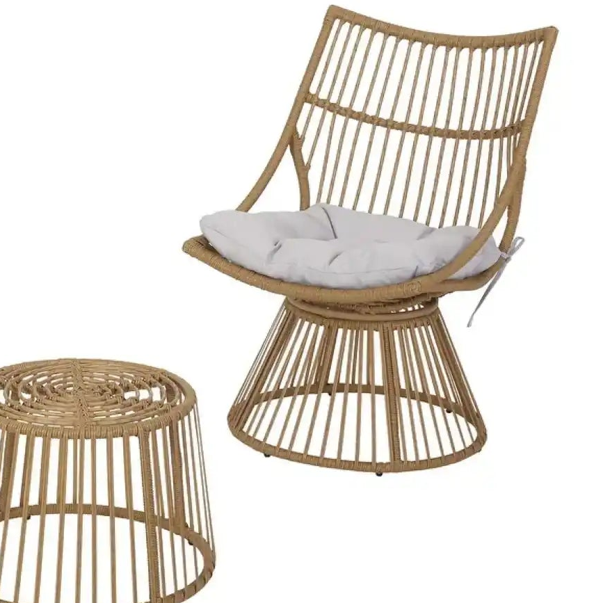 Wicker chair with a white cushion and matching wicker side table on a white background