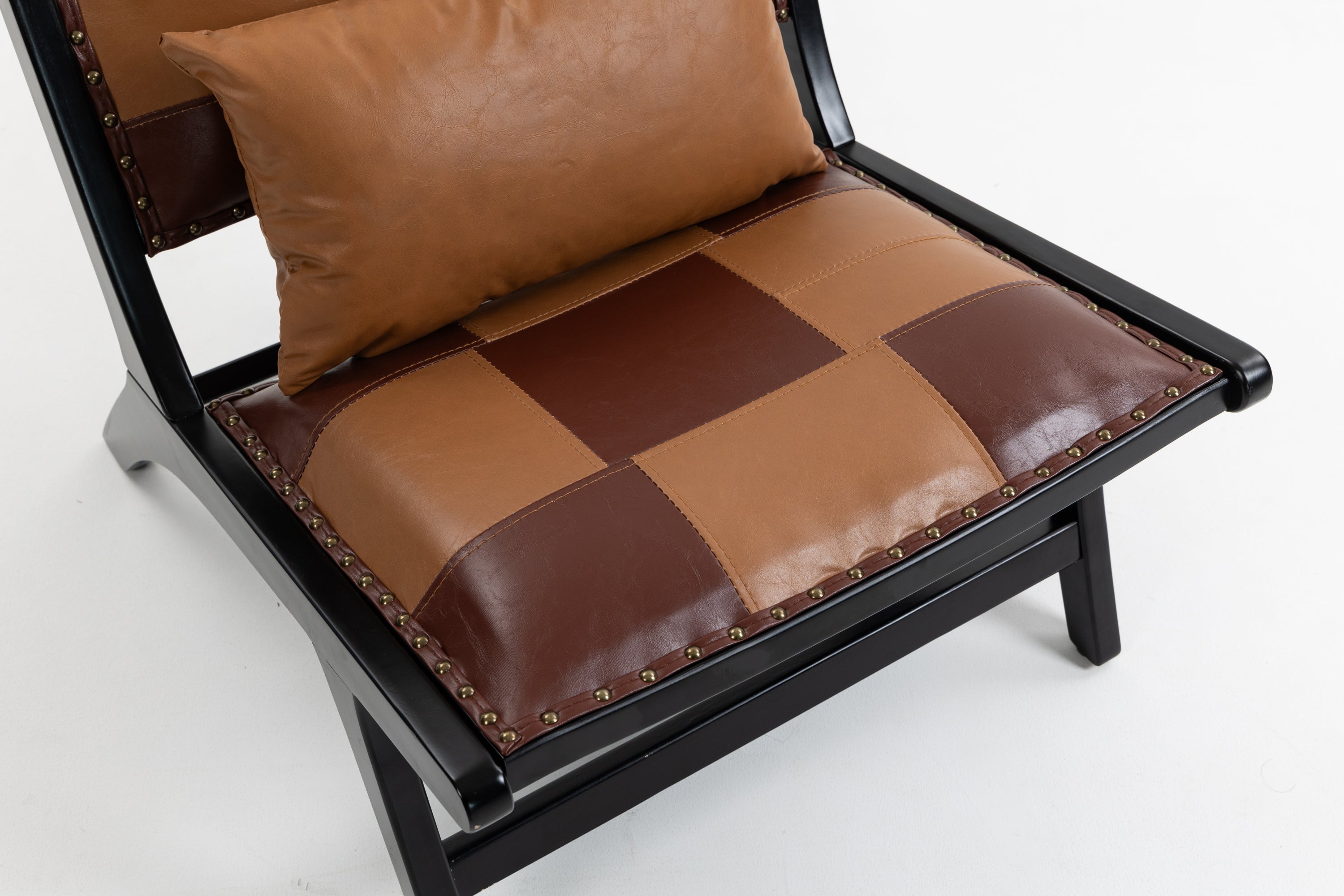 Brown leather patchwork chair with a pillow on a white background