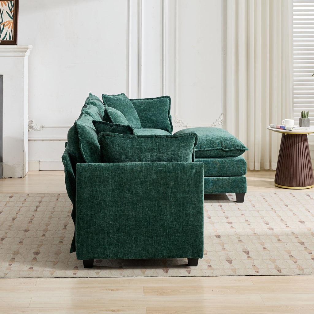 Green sofa in a living room setting with a side table and decor items.