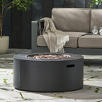 Outdoor fire pit table with a beige sofa and decorative elements in the background.