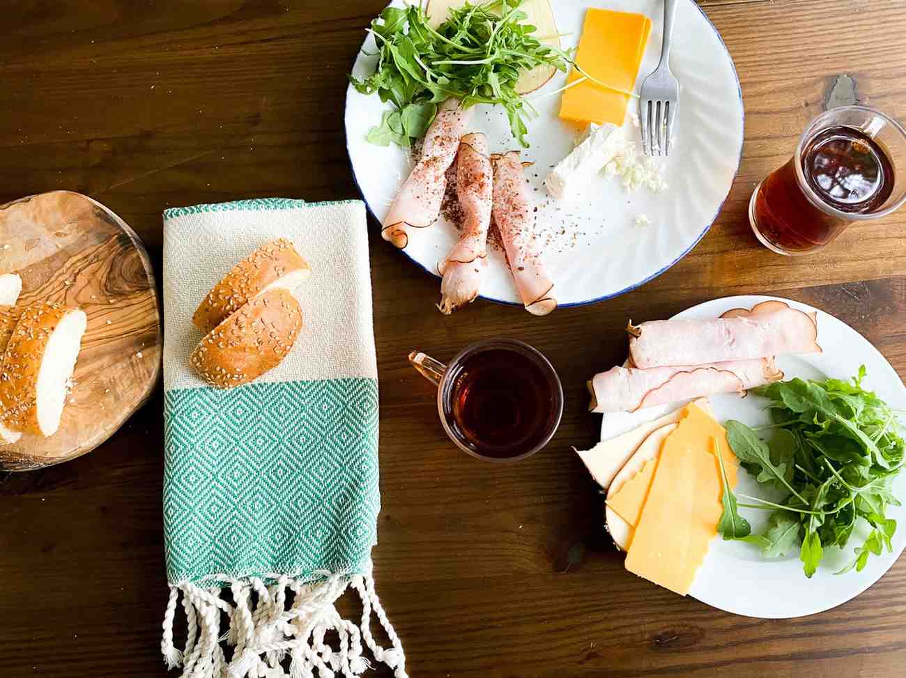 Eco-friendly Turkish tea guest towel with green geometric pattern, folded beside bread.