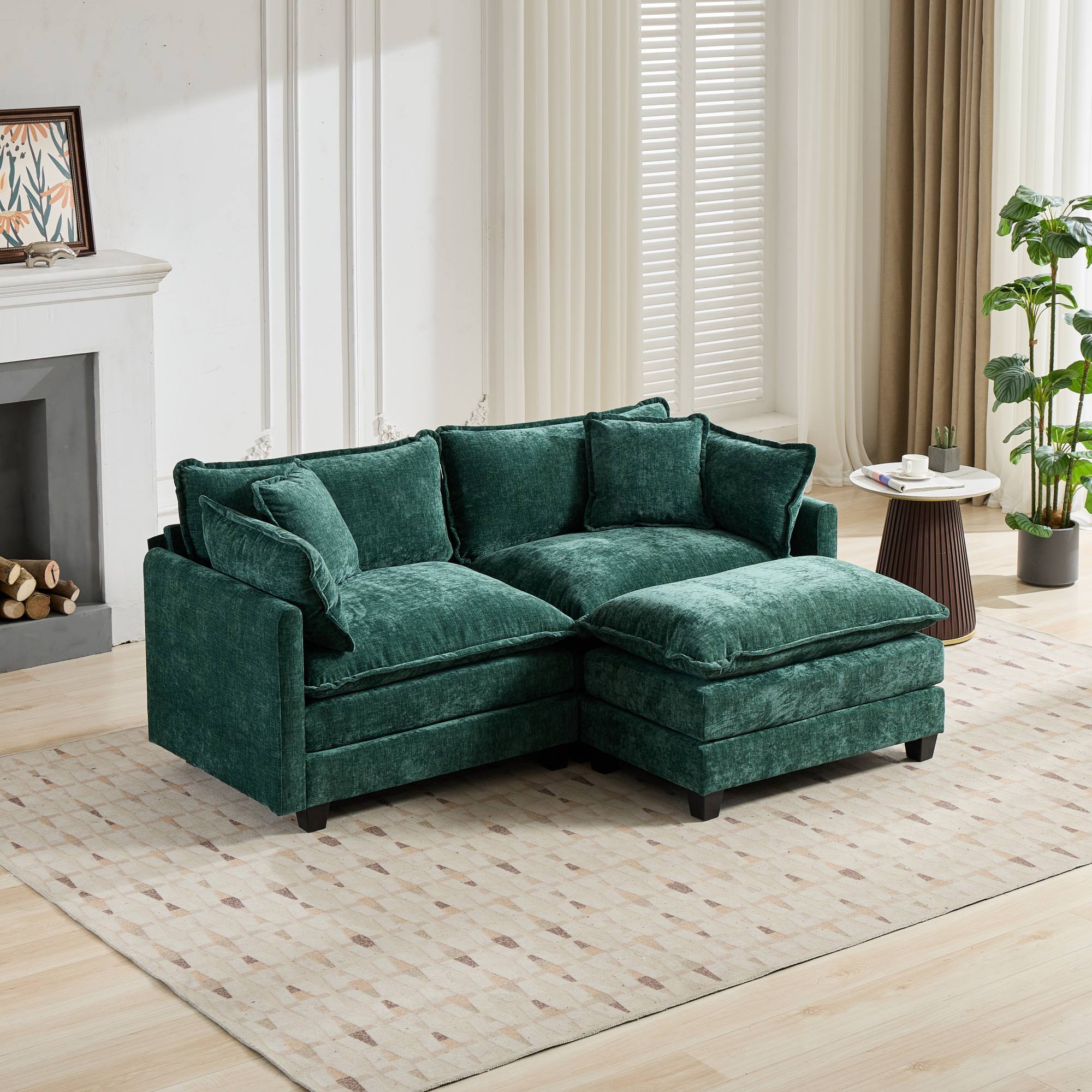 Green sectional sofa in a living room setting with a fireplace and plants.