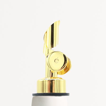 Gold-colored faucet handle on a white background