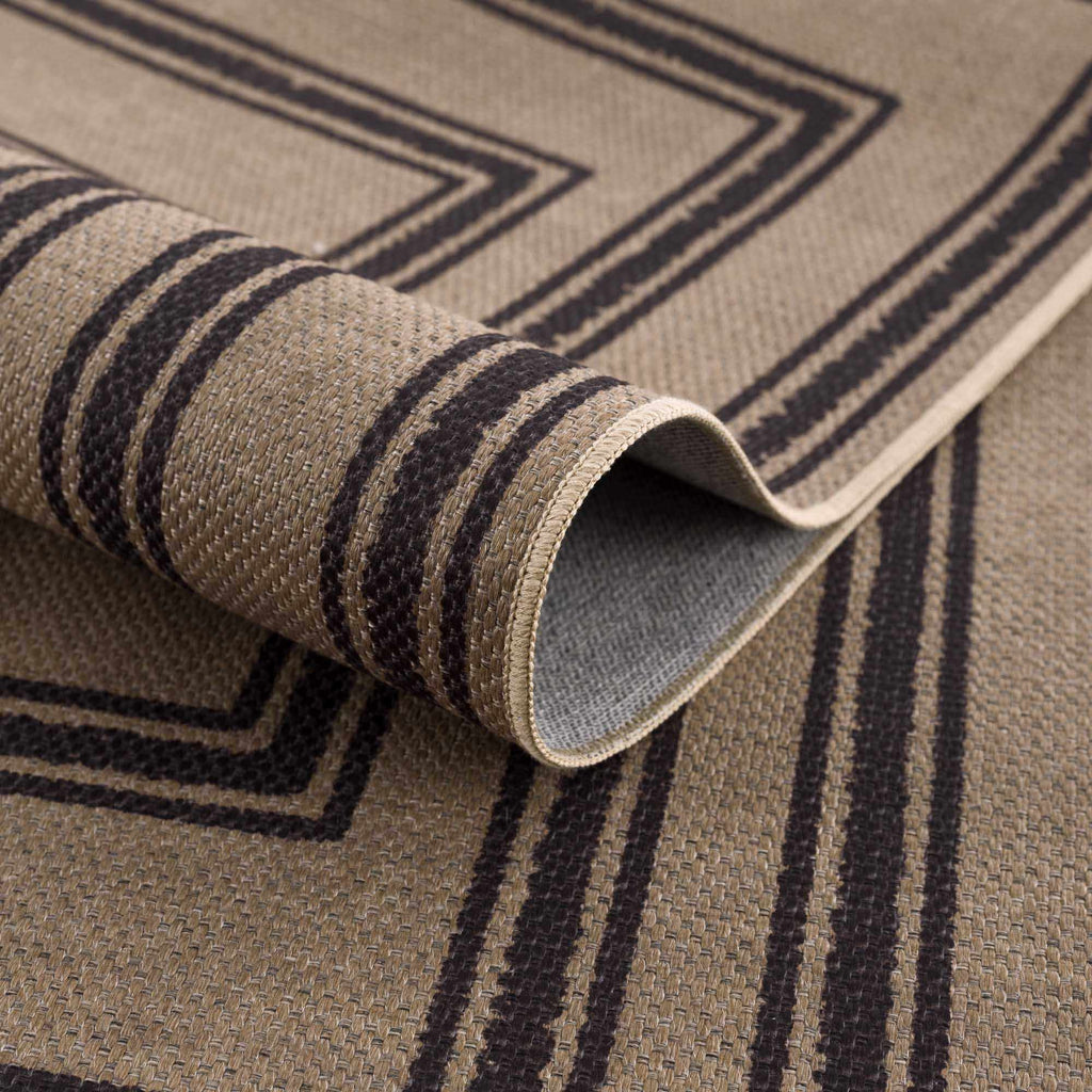 Close-up of a rolled-up rug with geometric pattern