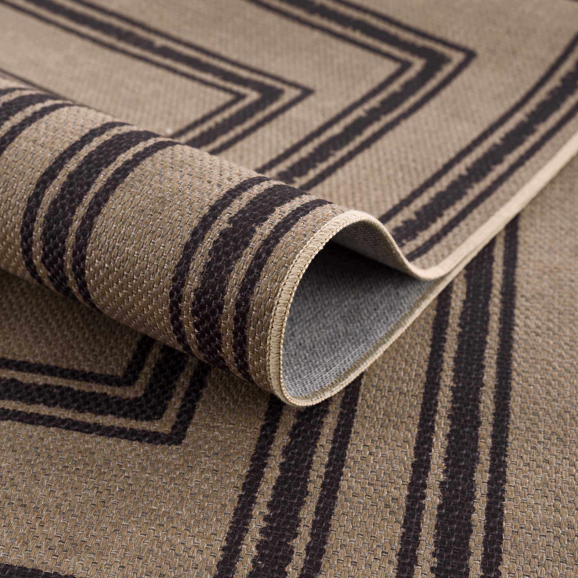 Close-up of a rolled-up rug with geometric pattern