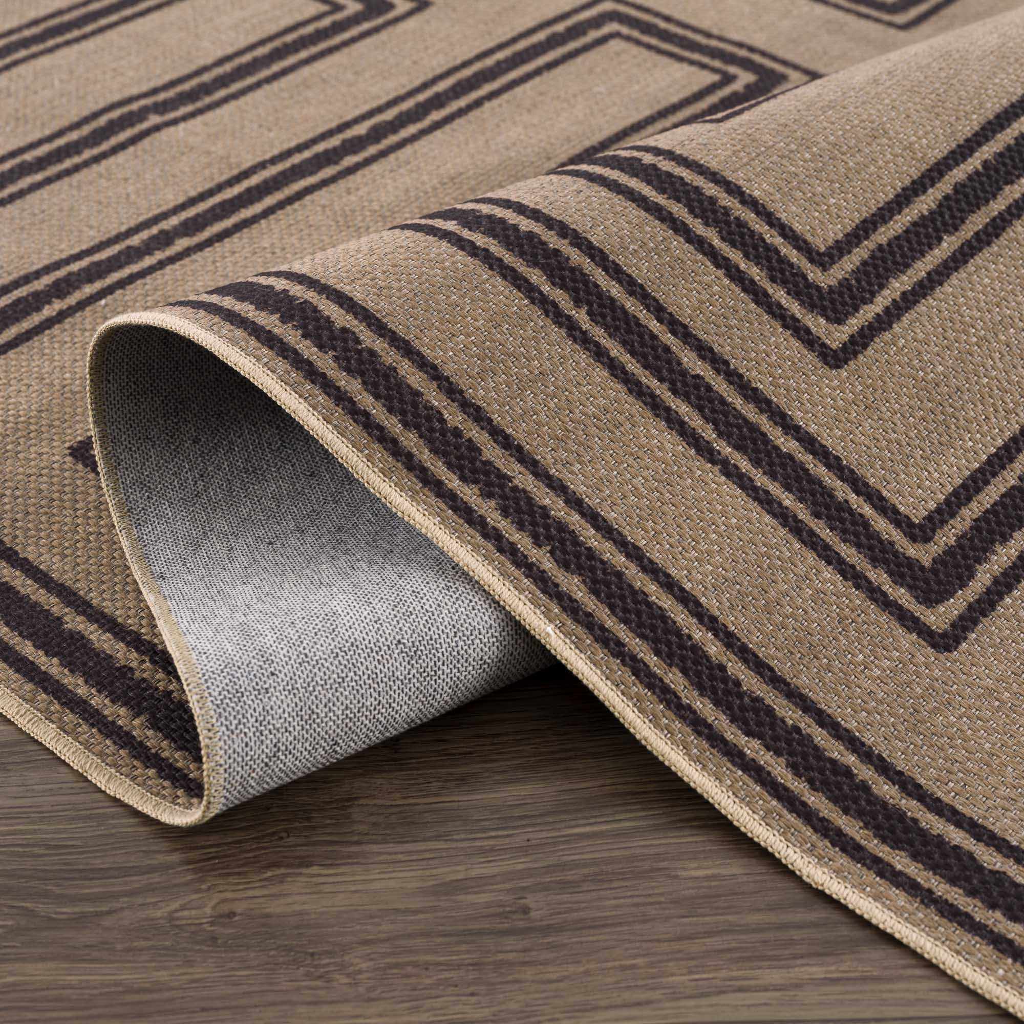 Brown and black patterned rug on a wooden floor