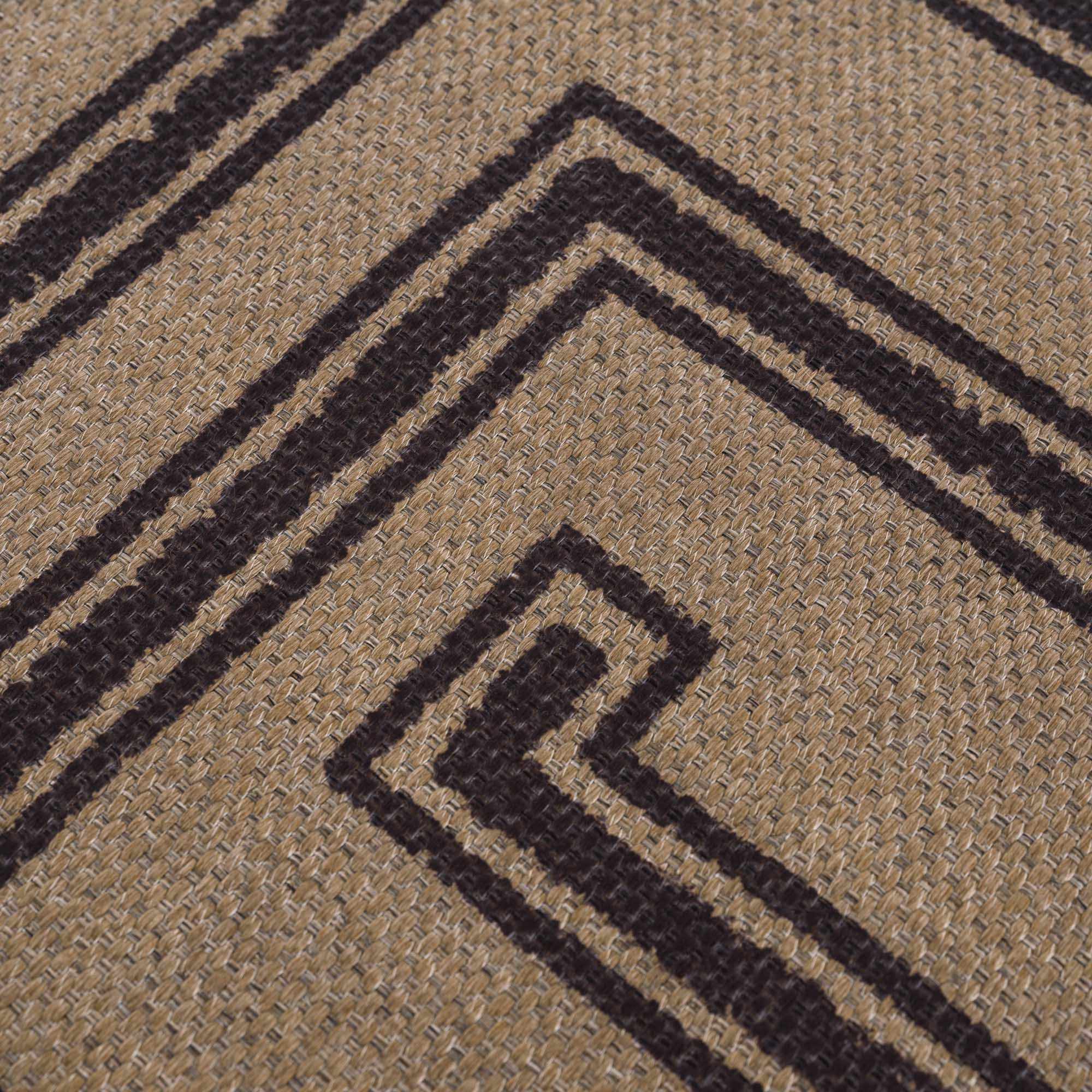 Close-up of a textured brown carpet with black geometric patterns