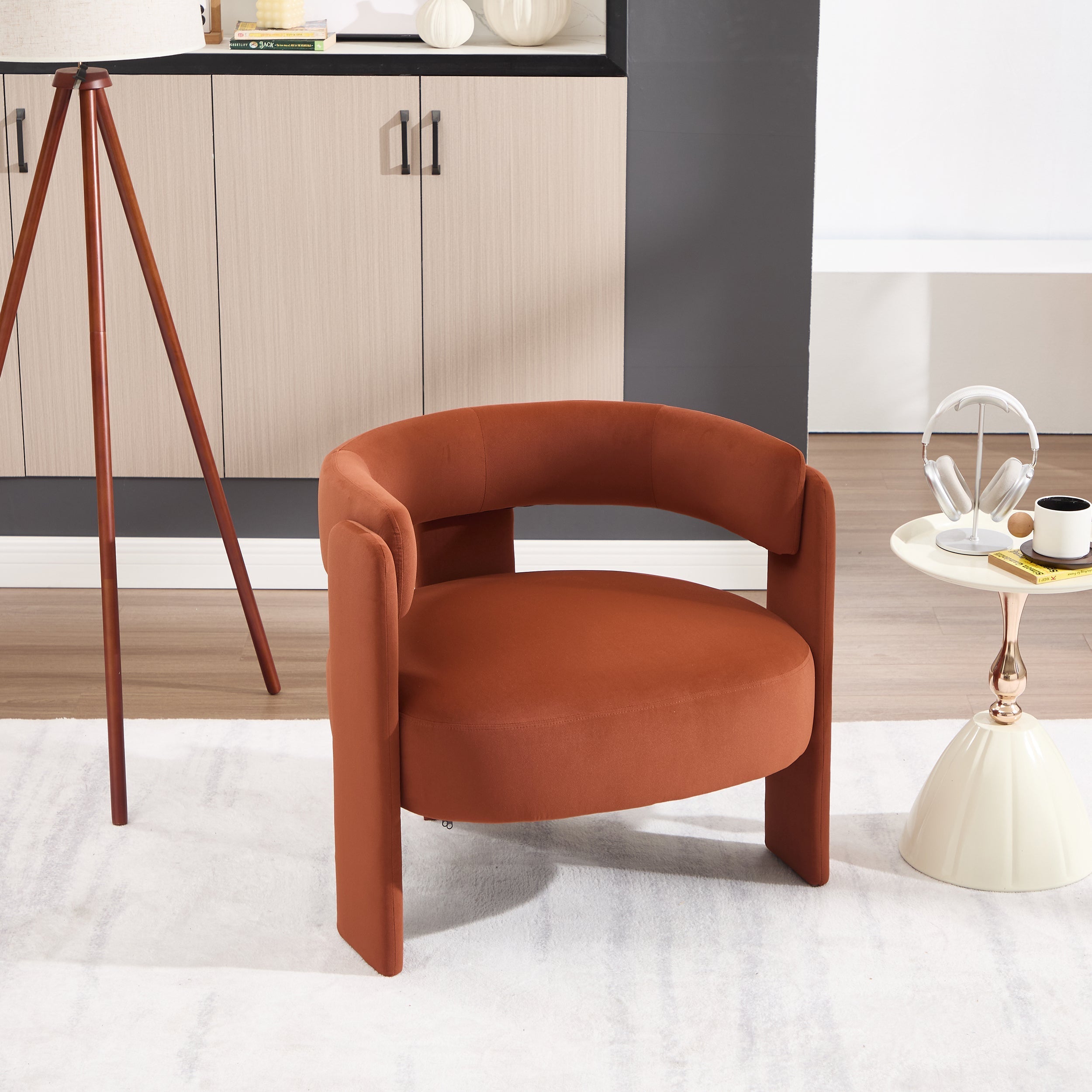 Brown armchair in a modern room with a cabinet and small table.