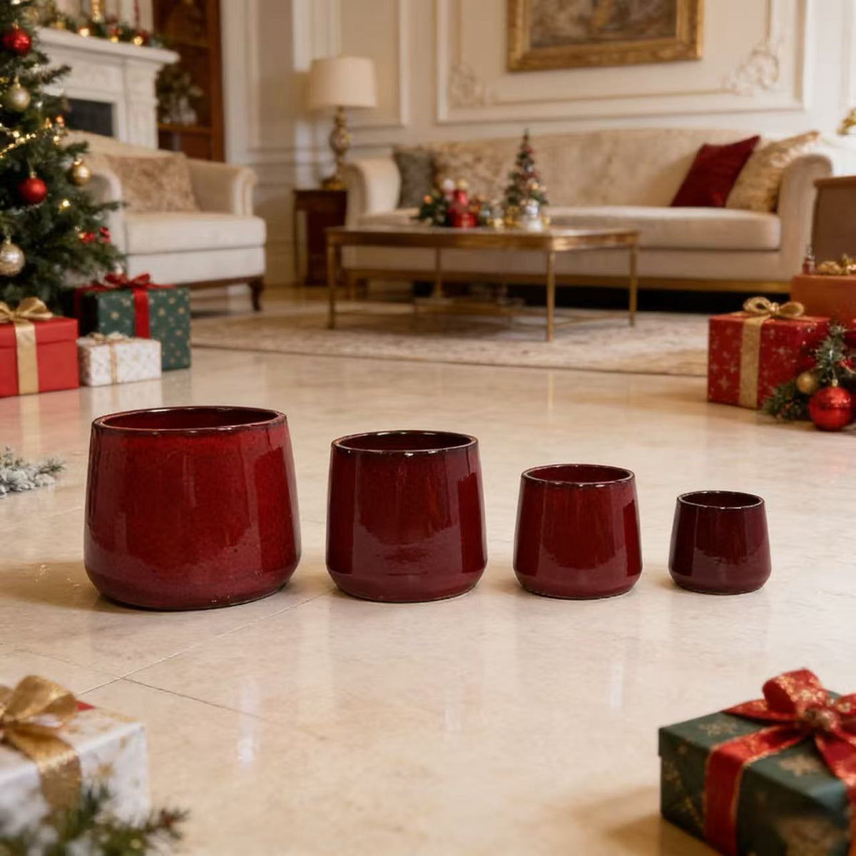 Four red ceramic pots on a tiled floor with Christmas decorations in the background.