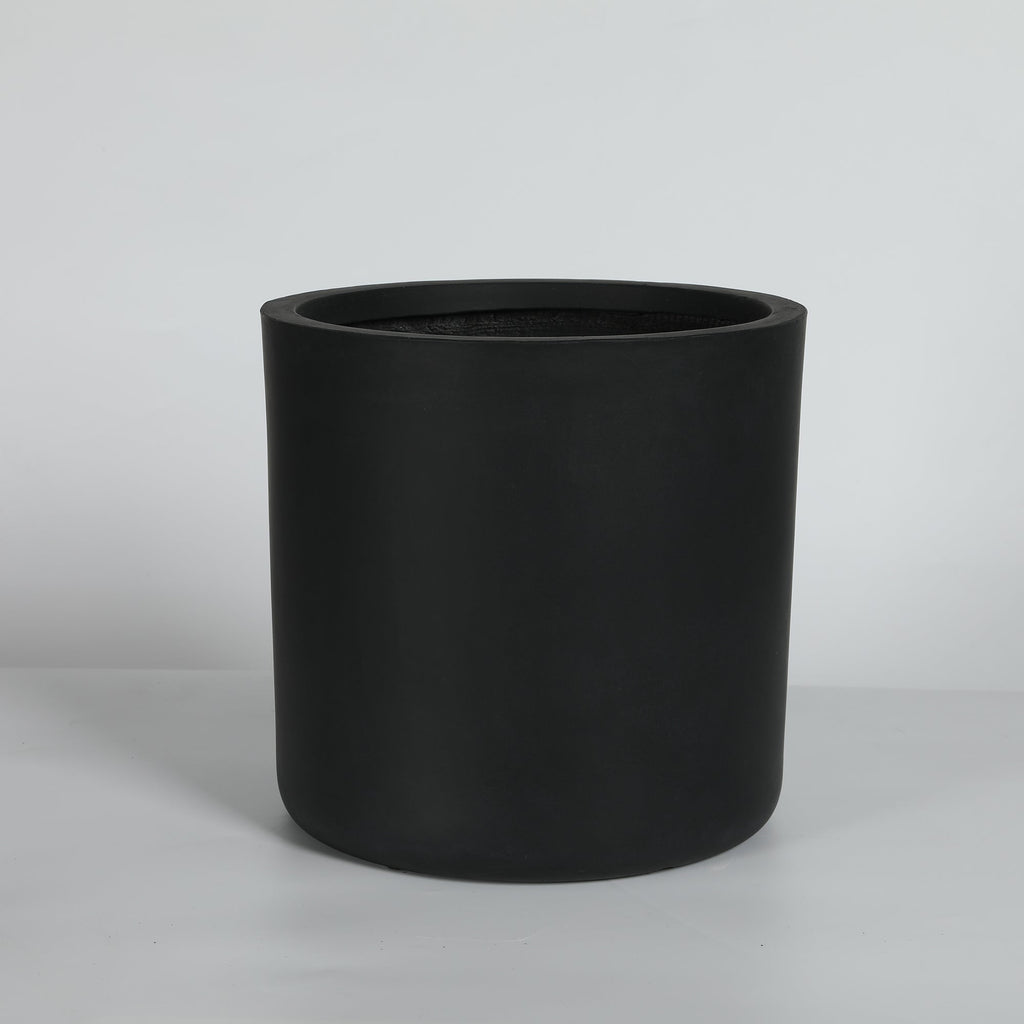 Black cylindrical planter on a light gray background