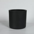 Black cylindrical planter on a light gray background