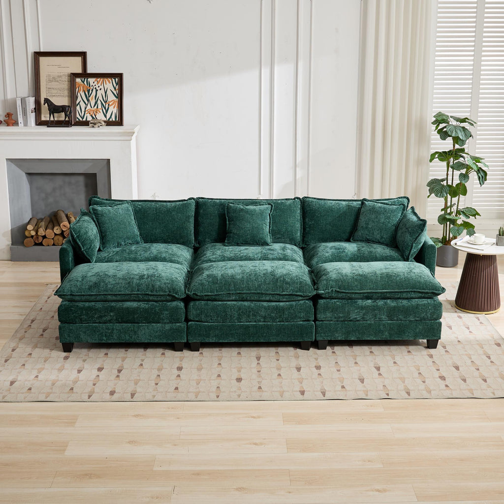 Green sectional sofa in a living room setting with a fireplace and decor.