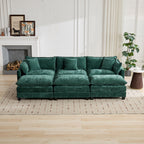 Green sectional sofa in a living room setting with a fireplace and decor.