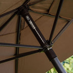 Close-up of a brown umbrella with visible joints and fabric texture.