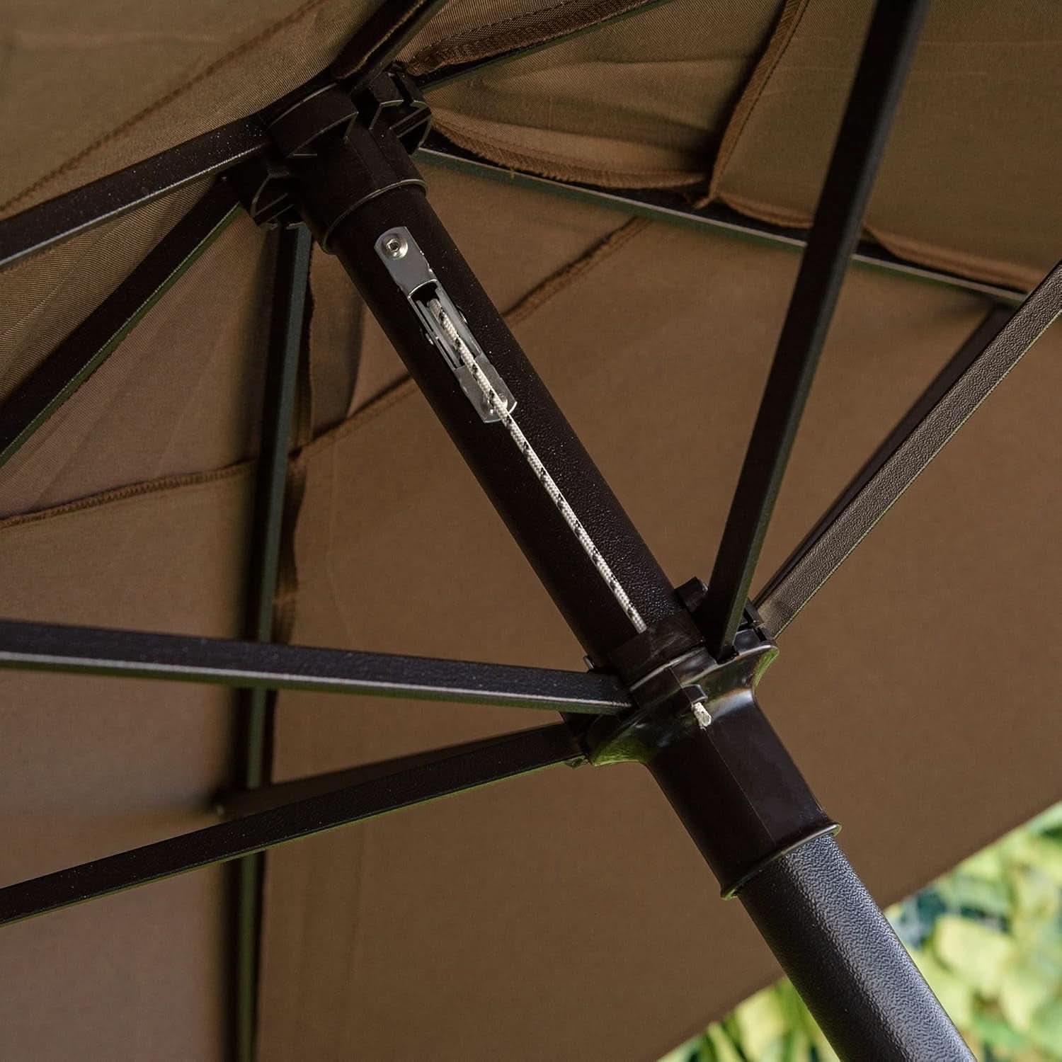 Close-up of a brown umbrella with visible joints and fabric texture.