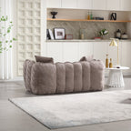 Gray sofa in a modern living room with shelves and decor.