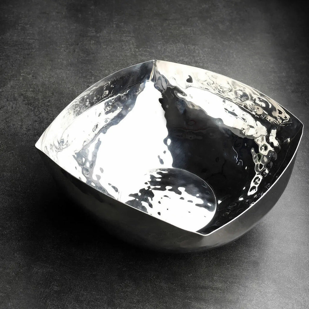 Silver bowl with a textured surface on a dark background