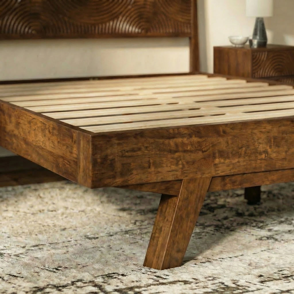 Wooden bed frame with a textured headboard in a bedroom setting.