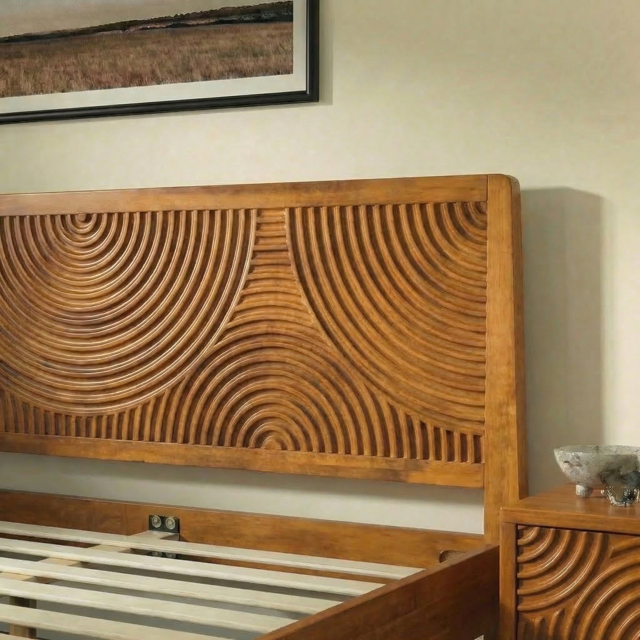 Wooden bed with intricate carvings on a beige wall.