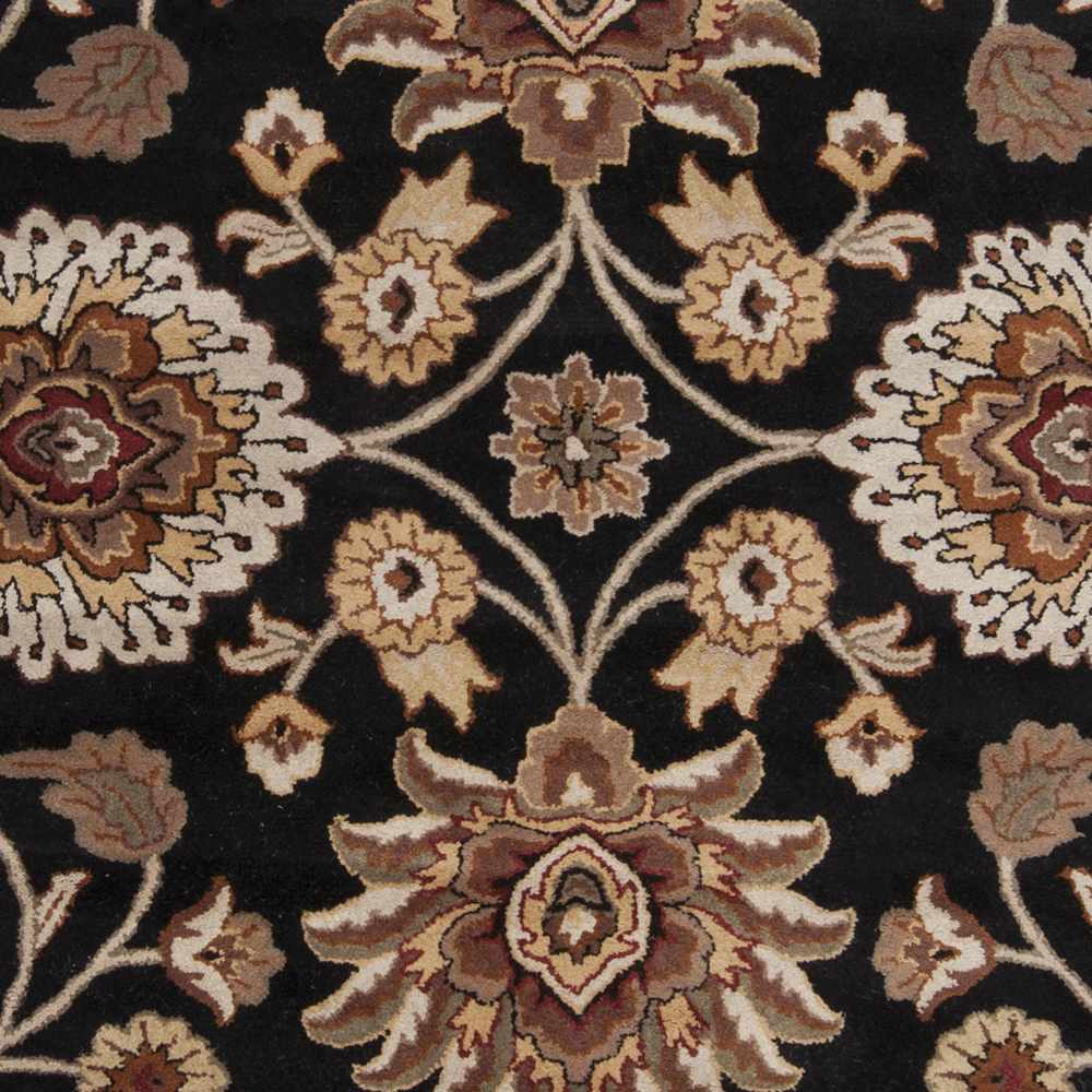 Close-up of a patterned rug with floral designs on a black background