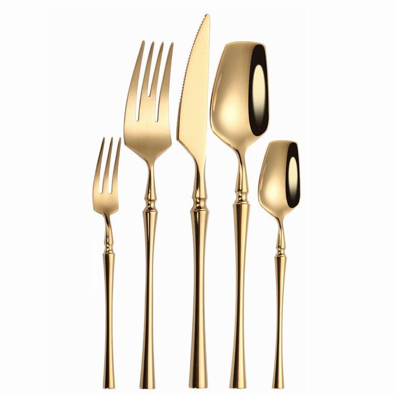 Set of gold-plated cutlery including forks, knife, and spoons on a white background