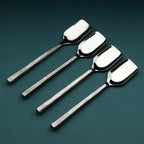 Set of four silver stilton spoons on a dark green background