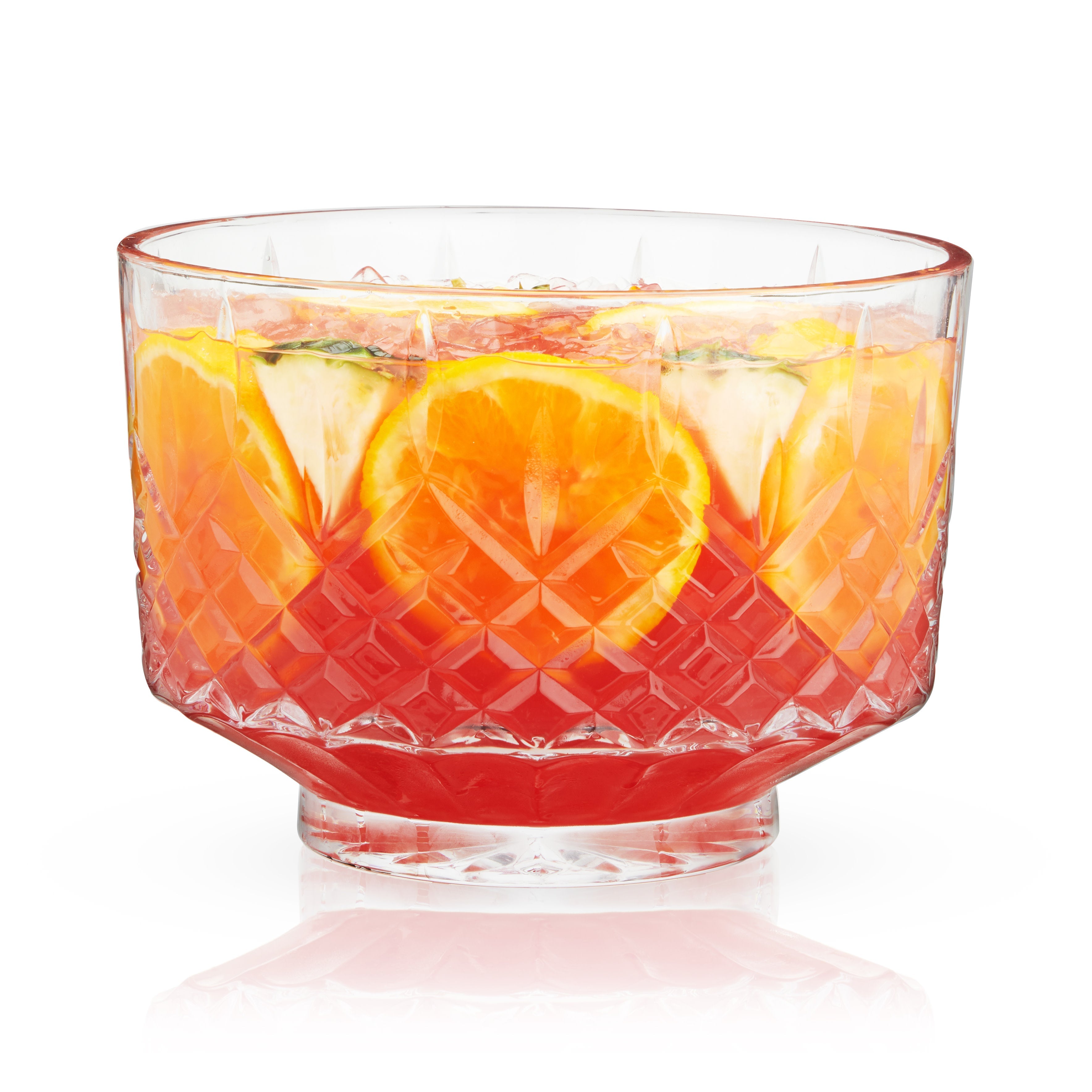 Clear glass bowl filled with a colorful fruit salad on a white background