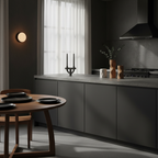 Modern kitchen with dark gray cabinets, wooden dining table, and minimal decor.