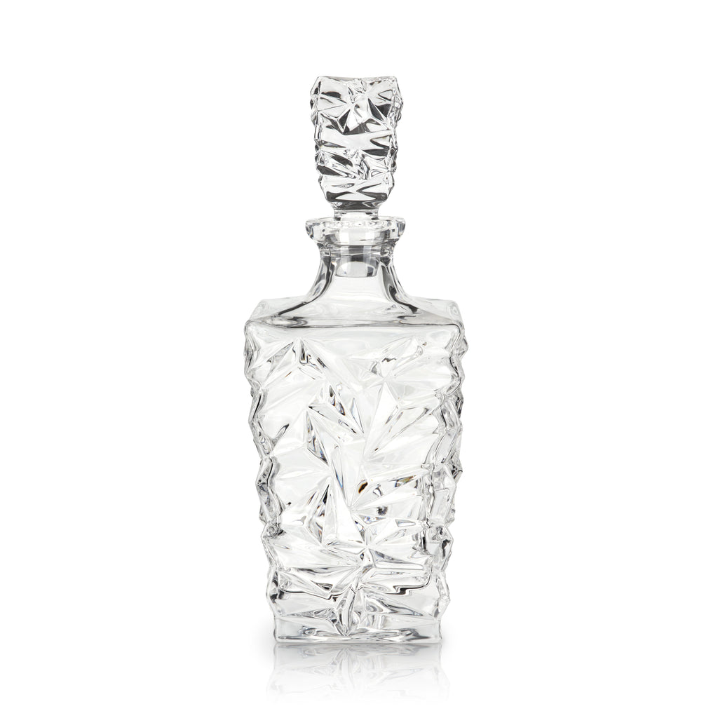 Clear glass decanter with textured design on a white background