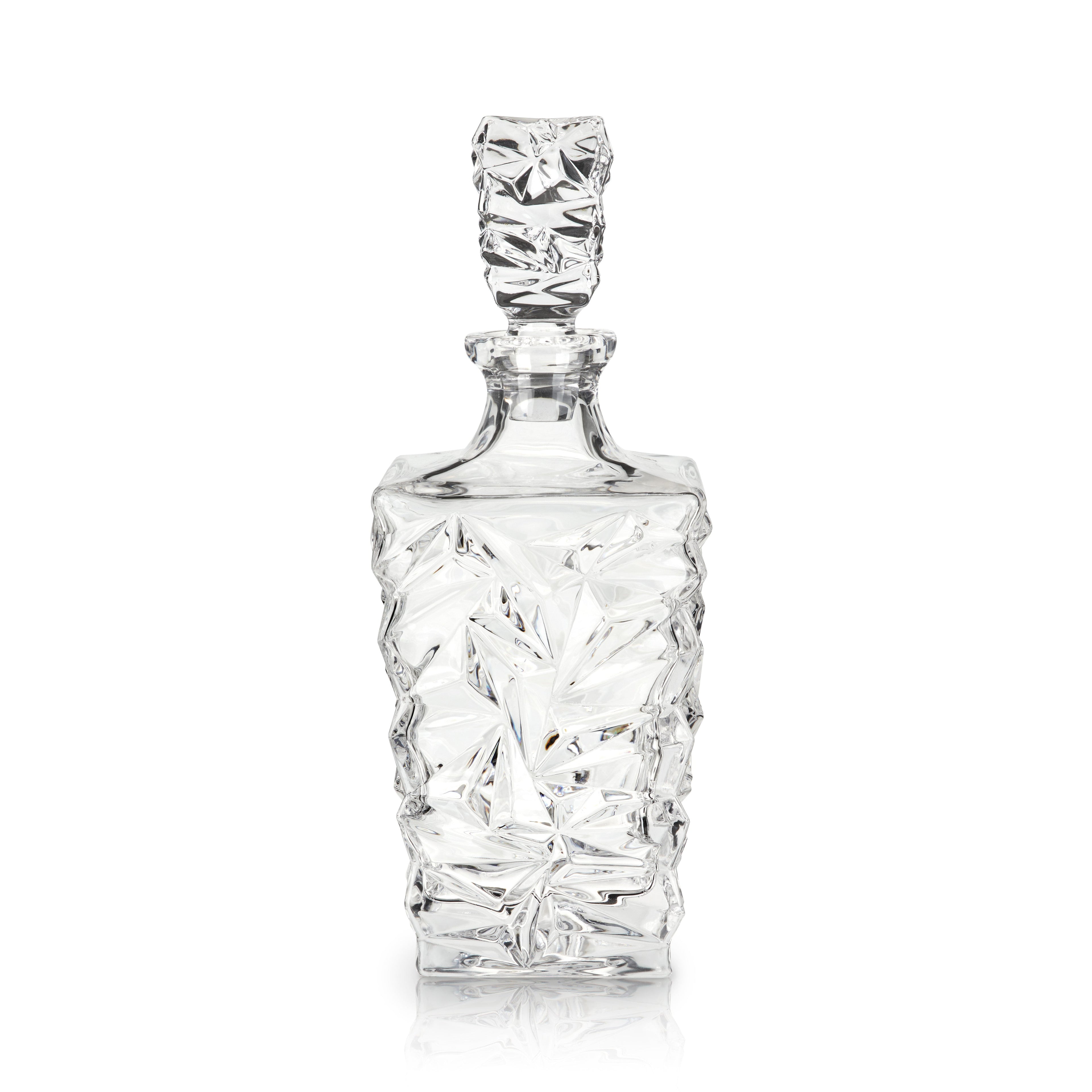 Clear glass decanter with textured design on a white background
