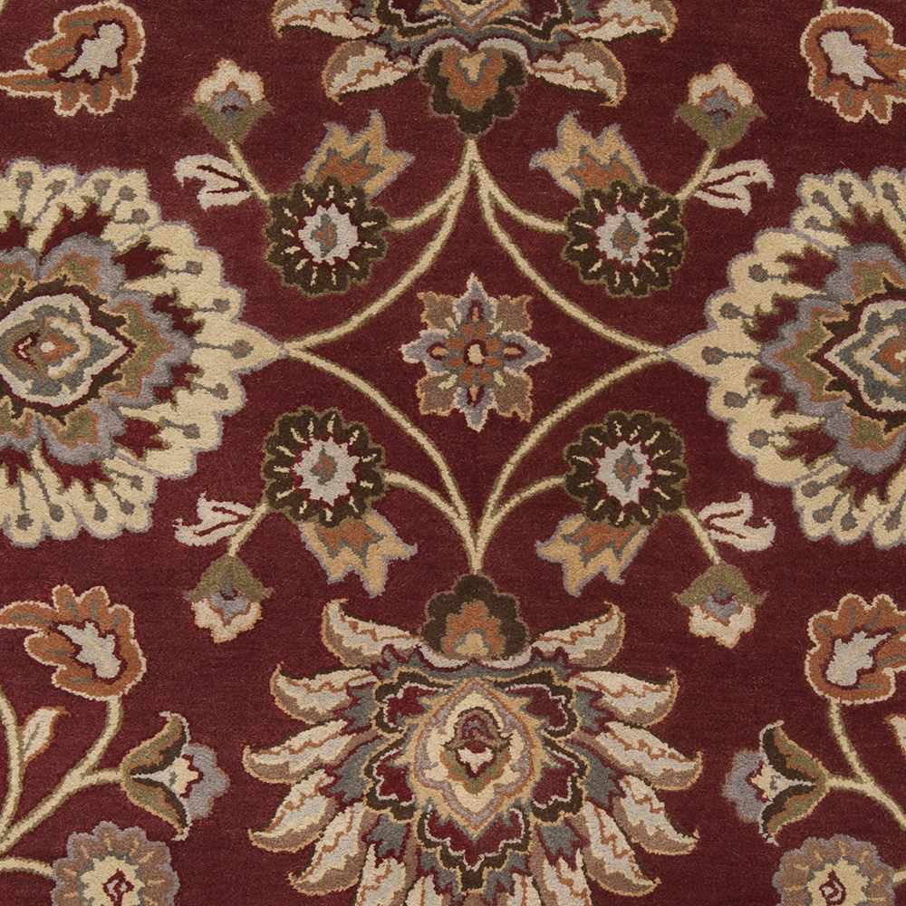 Close-up of a patterned rug with floral designs on a red background