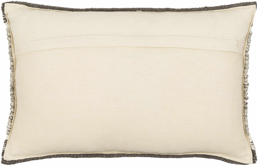 Beige pillow back with decorative trim on a beige background