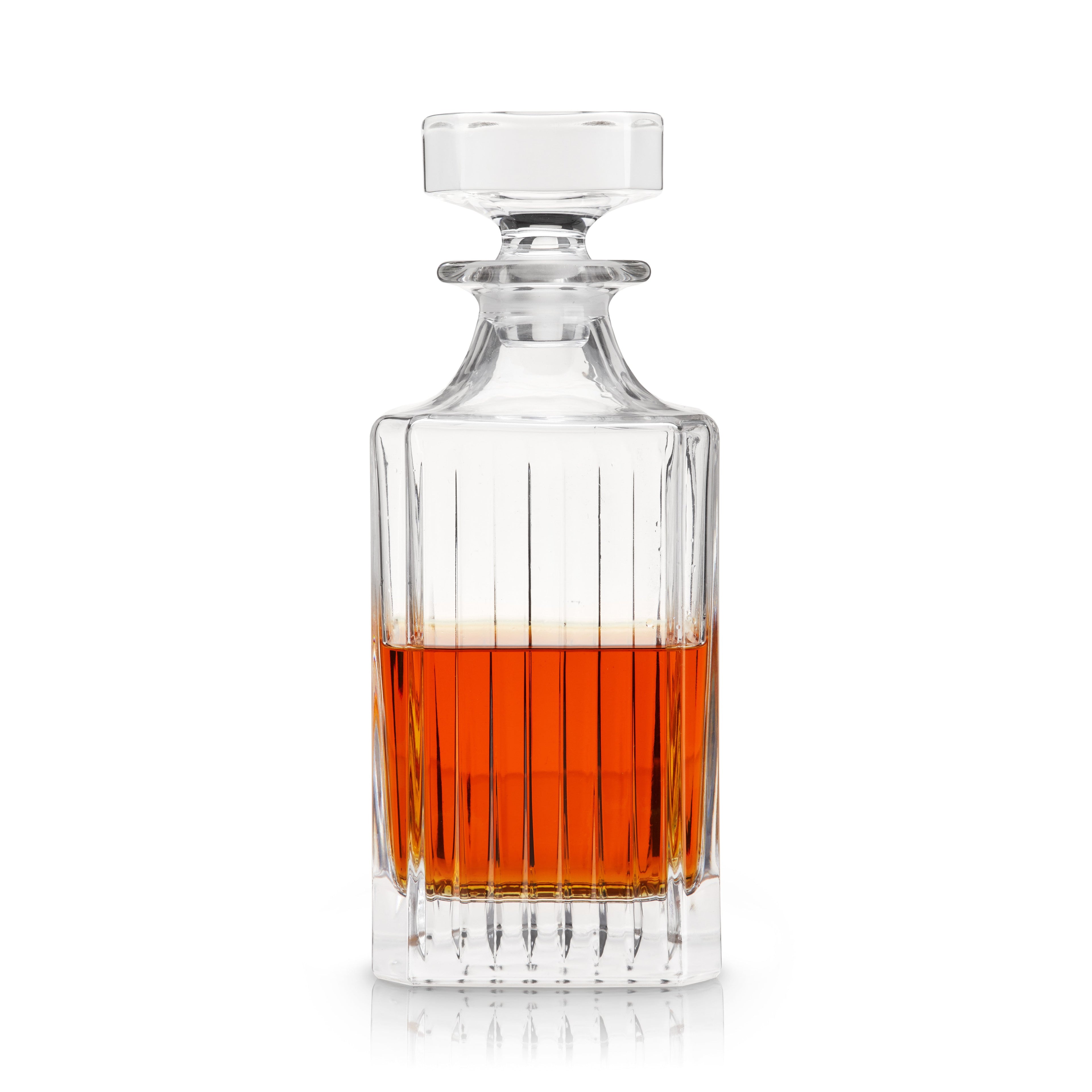 Clear glass decanter with amber liquid on a white background