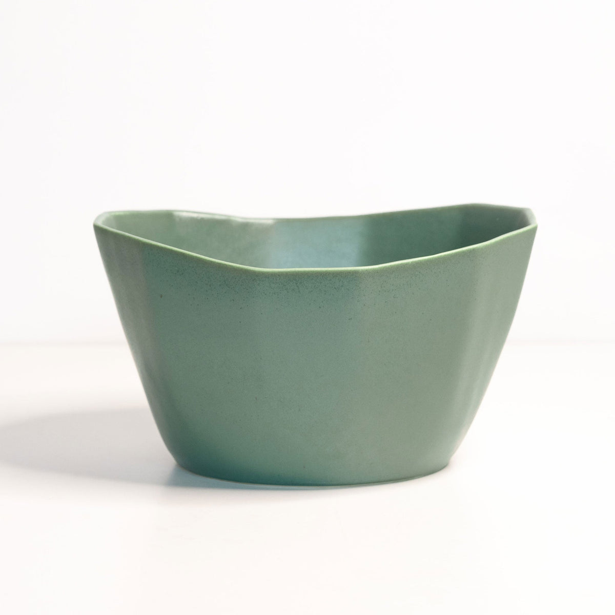 Green ceramic bowl on a white background